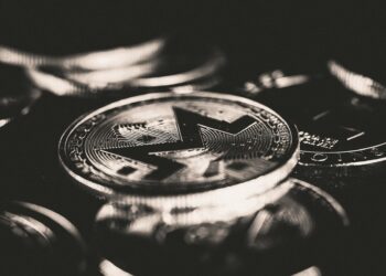 Securitize and TRON logos intertwined with digital asset icons on a tech background.