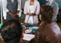 A group of diverse investors discussing cryptocurrency funding strategies.