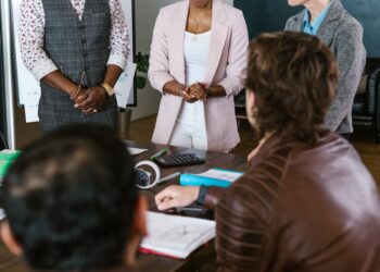 A group of diverse investors discussing cryptocurrency funding strategies.