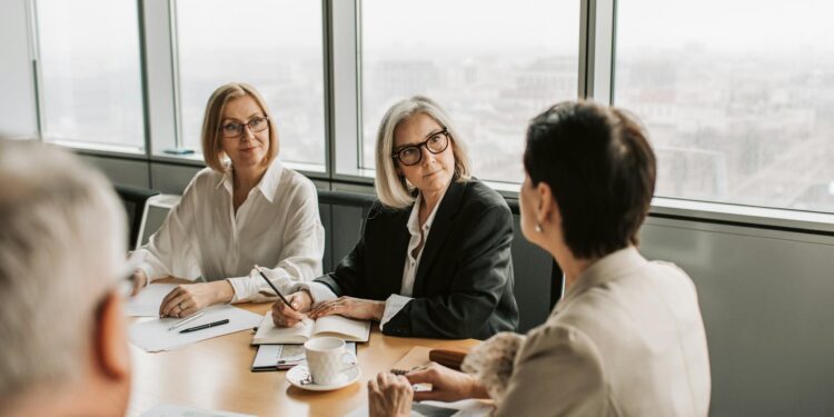 Central banks meeting around a table discussing stablecoin regulations and cooperation.