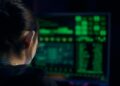 Police officers examining computer screens filled with cryptocurrency data and codes.