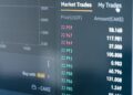A visual representation of cryptocurrency trades and tax documents on a digital screen.