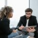 Banking professionals discussing blockchain technology in a modern financial office setting.