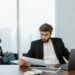 Bank executive reviewing cybersecurity reports with cybersecurity icons in the background.
