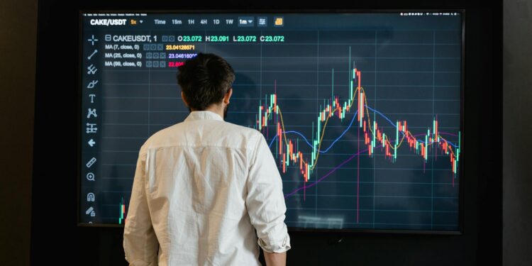 A financial analyst reviewing cryptocurrency trends on a digital interface.