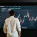 A financial analyst reviewing cryptocurrency trends on a digital interface.