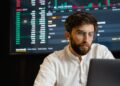 A digital illustration of a job seeker analyzing blockchain data on a computer screen.