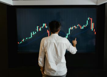 Traders analyzing crypto charts on screens during Polymarket exchange upgrade announcement.