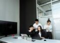 Allbirds team brainstorming over laptops, discussing AI technology for business solutions.