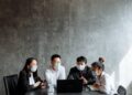OpenAI representatives discussing child safety measures at a conference table.