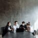 OpenAI representatives discussing child safety measures at a conference table.