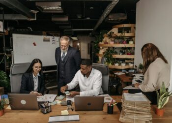 Financial professionals discussing stablecoin service in a modern office setting.