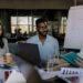 Marketing team meeting with crypto graphics and charts in a modern office setting.