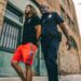Young man in handcuffs being escorted by police in front of a crowd, reflecting crypto controversy.
