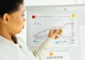 A financial analyst reviews charts and reports on cryptocurrency investments.