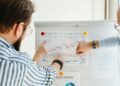 Aave team discusses crypto strategy in front of financial charts and data analytics.