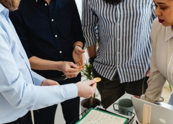 A group of diverse investors discusses cryptocurrency trends and stablecoin investments.