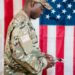 US soldier in military uniform with financial charts and Polymarket logo in the background.