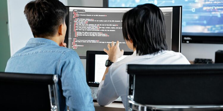 Aave developers discussing strategies for improving rsETH collateral ratio on digital screens.