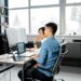 Developers collaborating on a Bitcoin project with code and digital screens in a tech workspace.