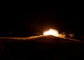 Explosions light up the night sky near Bushehr amid escalating attacks and heightened tensions.