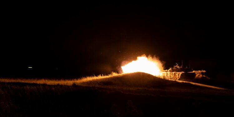 Explosions light up the night sky near Bushehr amid escalating attacks and heightened tensions.