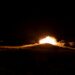 Explosions light up the night sky near Bushehr amid escalating attacks and heightened tensions.