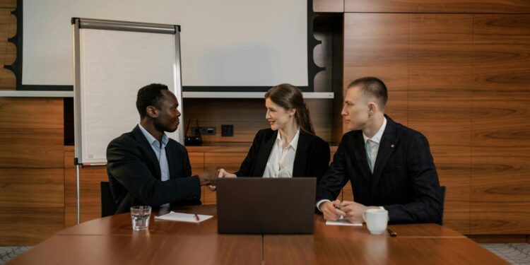Microsoft and OpenAI executives discuss partnership adjustments over a conference table.