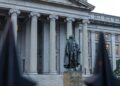 US Treasury building with cryptocurrency symbols, highlighting new AML regulations for stablecoins.