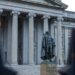 US Treasury building with cryptocurrency symbols, highlighting new AML regulations for stablecoins.