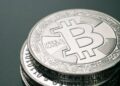 Stacks of digital currency tokens with a burning effect, symbolizing token burn strategy.
