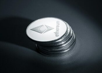 Stack of coins with Ethereum logo, symbolizing Bitmine's crypto asset acquisition.