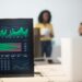 Oil trading floor with screens showing prices, traders discussing strategy in a busy environment.