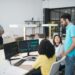 A futuristic office space with diverse team members discussing AI and blockchain technology.