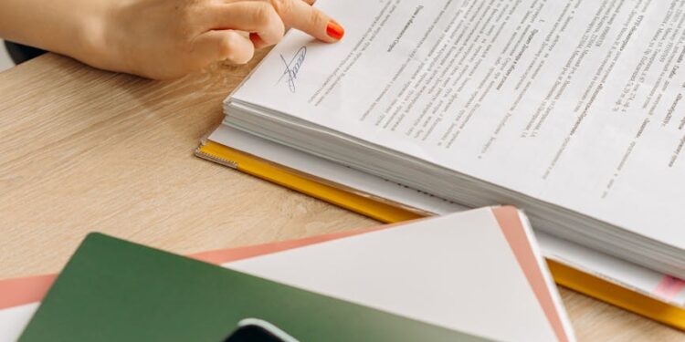 A person examines cryptocurrency symbols and regulatory documents on a desk.