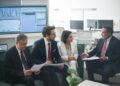 Banking officials discuss stablecoin regulations in a financial conference setting.