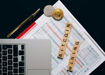 Bitcoin mining hardware displayed on a table, with logos of Tether, Canaan, and ACME visible.
