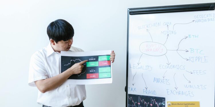 Investors discussing cryptocurrency charts at a financial conference in Vietnam.