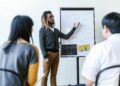 A diverse group of professionals engages in a blockchain education workshop.