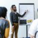 A diverse group of professionals engages in a blockchain education workshop.