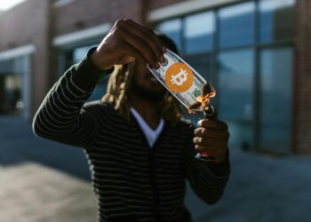 Fire visual representing a cryptocurrency token burn and buyback, with coins dissipating into smoke.