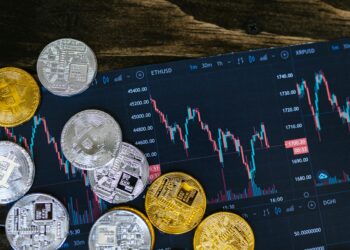 Digital illustration of cryptocurrency symbols with financial charts and tokens representing payroll.