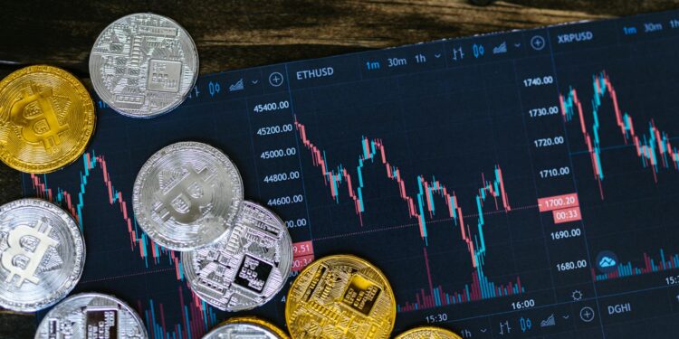 A digital display shows various cryptocurrency tokens and financial graphs.