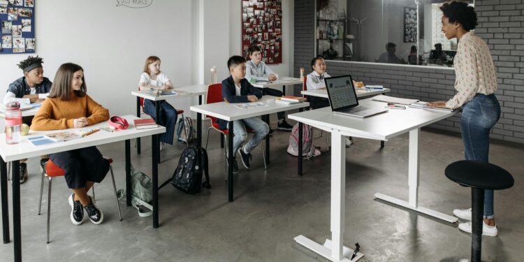 Bitcoin logo superimposed on a classroom setting with students and teachers engaging in learning.