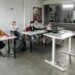 Bitcoin logo superimposed on a classroom setting with students and teachers engaging in learning.