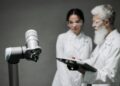 A group of engineers examining advanced robotics powered by new trillion-parameter AI technology.