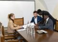 A diverse group of leaders at a conference discussing blockchain and finance innovations.