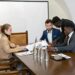 A diverse group of leaders at a conference discussing blockchain and finance innovations.