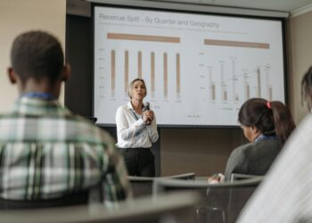 Sam Altman speaking at a conference, with graphs and charts on AI investments in the background.