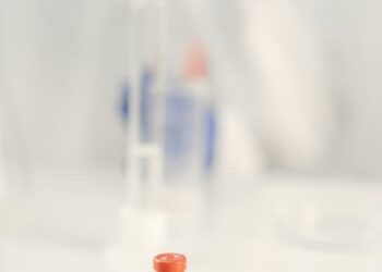 Vaccination research laboratory with scientists studying vaccine data and responses.